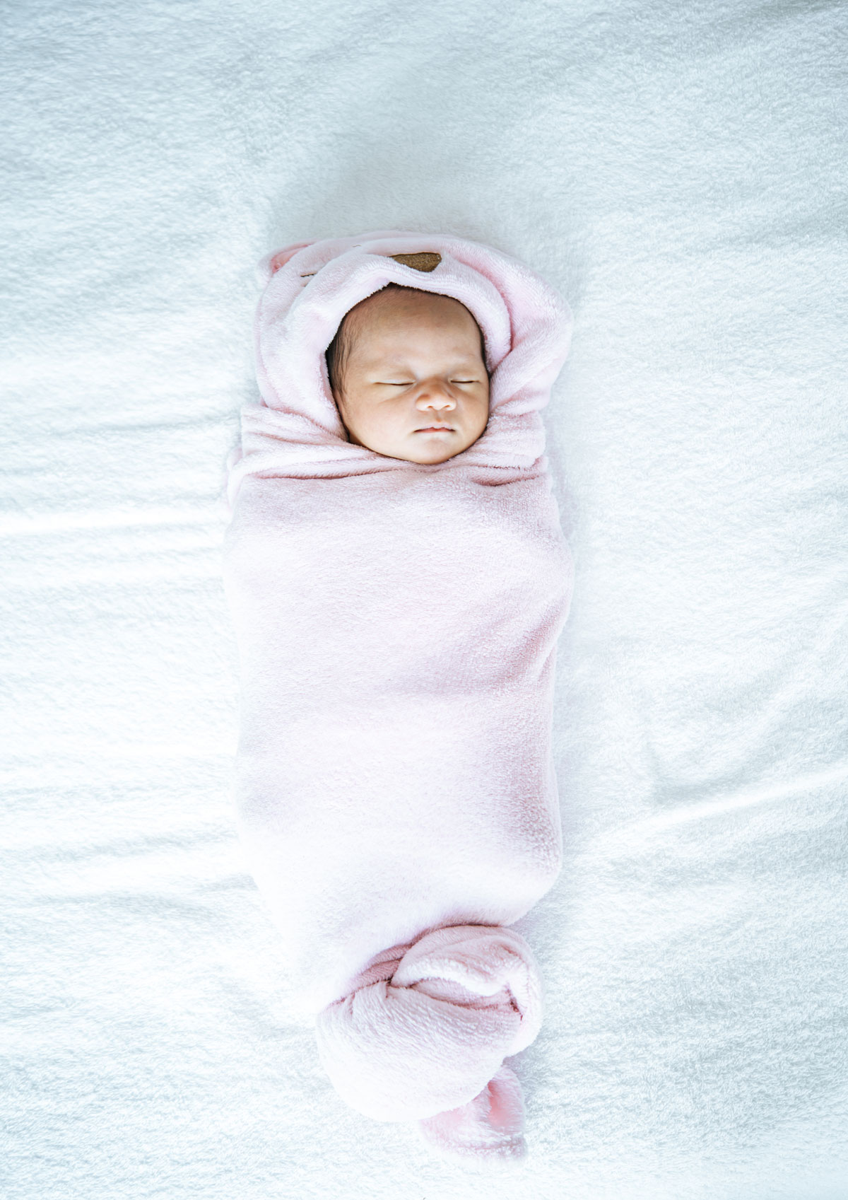 newborn-baby-sleeping-soft-pink-blanket